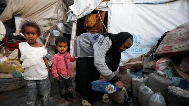 epa10541342 Yemeni children stand next to their grandmother at a makeshift camp for Internally Displaced Persons (IDPs) in Sana'a, Yemen, 23 March 2023 (issued 24 March 2023). More than 11 million children in Yemen require urgent humanitarian aid as they could face greater risks of malnutrition due to the consequences of eight years of the endless and crushing war in the Arab country, the United Nations Children's Agency (UNICEF) has warned. The protracted war in Yemen is referred to as the Saudi Arabia-Iran proxy conflict in which the warring parties have been militarily and politically backed by Saudi Arabia and Iran respectively since 2015. EPA/YAHYA ARHAB