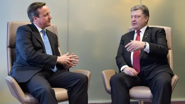 epa04615953 Great Britain's Prime Minister David Cameron (L) and Ukrainian President Petro Poroshenko (R) during a bilateral meeting at the European Summit of Heads of States and governments at the EU Council headquarters, Belgium, 12 February 2015. The EU summit started two hours later than planned, after two of its participants - German Chancellor Angela Merkel and French President Francois Hollande - spent all night negotiating a Ukraine truce deal in Minsk. The European Union leaders are meeting to discuss Greece's economic crisis, EU counterterrorism efforts and the situation in Ukraine. EPA/ERIC VIDAL / POOL