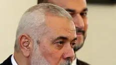 epa11244404 Hamas leader Ismail Haniyeh (L) speaks to the media as Iranian Foreign Minister Hossein Amir Abdoulhian (R) looks on, in Tehran, Iran, 26 March 2024. Haniyeh is in Tehran to meet with Iranian officials. EPA/ABEDIN TAHERKENAREH