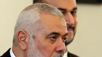 epa11244404 Hamas leader Ismail Haniyeh (L) speaks to the media as Iranian Foreign Minister Hossein Amir Abdoulhian (R) looks on, in Tehran, Iran, 26 March 2024. Haniyeh is in Tehran to meet with Iranian officials. EPA/ABEDIN TAHERKENAREH