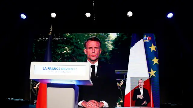epa11400683 French President Emmanuel Macron is displayed on a large screen during a televised address to the nation, at the electoral party of the French right-wing party National Rally (Rassemblement National or RN) in Paris, France, 09 June 2024, after the first results of the European elections. The French president announced the dissolution of the National Assembly, the French Parliament lower house, and called for new general elections after his party suffered defeat in the European elections. The list of the Rassemblement National, led by party chief Jordan Bardella, is given winner in France according to first estimations after polls. EPA/ANDRE PAIN