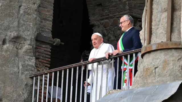 Pope Francis (L) is flanked by Rome's Mayor Roberto Gualtieri, looks on from a balcony overlooking the Roman Forum, during his visit to Campidoglio (Capitoline hill) in Rome, Italy, 10 June 2024. ANSA/ETTORE FERRARI