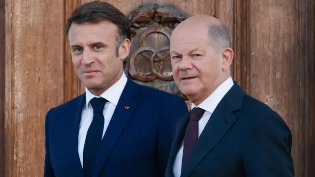 epa11376268 French President Emmanuel Macron (L) and German Chancellor Olaf Scholz arrive for a family photo at Meseberg Palace in Meseberg near Gransee, Germany, 28 May 2024. French President Emmanuel Macron visits Germany from 26 to 28 May. French President Emmanuel Macron visits Germany from 26 to 28 May. After appointments with Federal President Steinmeier in German regions Berlin, Dresden and Muenster, Macron meets German Chancellor Olaf Scholz at Meseberg Palace on 28 May 2024 for a Franco-German Council of Ministers. EPA/CLEMENS BILAN