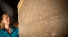 epa10235848 A British Museum staff poses next to the Rosetta Stone during a photocall for the upcoming 'Hieroglyphs: unlocking ancient Egypt' exhibition at British Museum in London, Britain, 11 October 2022. The exhibition explores how the Rosetta Stone helped academics to decipher Egyptian hieroglyphics in 1822 and brings together 240 artefacts. The exhibition runs from 13 October 2022 to 19 February 2023. EPA/TOLGA AKMEN