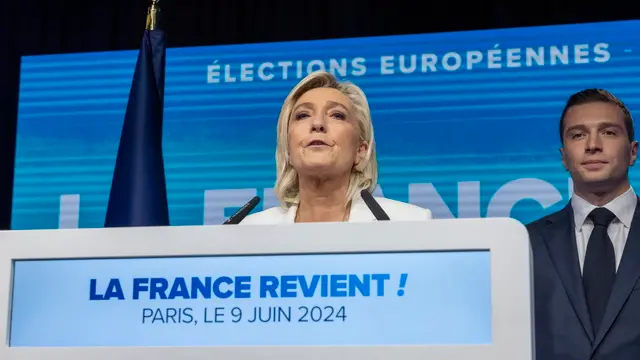 epa11401161 National Rally parliamentary party leader Marine Le Pen delivers a speech standing next to RN president Jordan Bardella (R) at the electoral party of the French right-wing party National Rally (Rassemblement National or RN) in Paris, France, 09 June 2024, after the first results of the European Elections. The list of the Rassemblement National, led by party chief Jordan Bardella, is given winner in France according to first estimations after polls. EPA/ANDRE PAIN