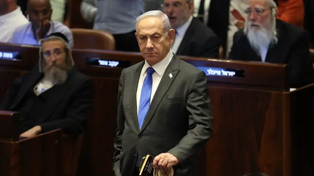 epaselect epa11403053 Israeli Prime Minister Benjamin Netanyahu (C) attends the Knesset plenum vote on the ultra-Orthodox conscription to military service law, in the Knesset, Israeli parliament in Jerusalem, 10 June 2024. The Knesset vote on the controversial exemption for ultra-Orthodox Yeshiva students from military conscription. Israelâ€™s Supreme Court heard on 02 June a response by the state over the ultra-Orthodox recruitment issue, after previously extending a deadline for the government to present a conscription plan for ultra-Orthodox Jews, who are traditionally exempt from military service. EPA/ABIR SULTAN