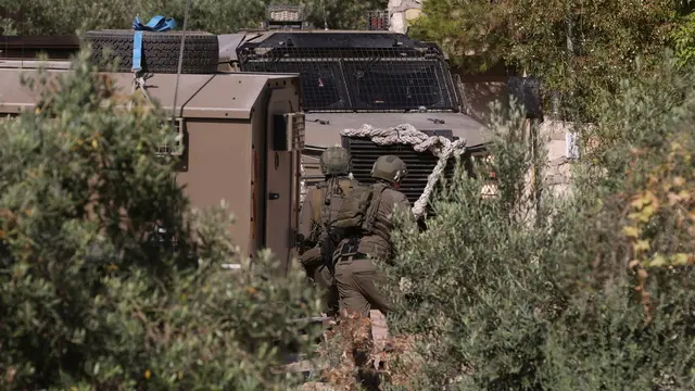 epa11402318 Israeli soldiers conduct a raid at Al Farea refugee camp near the West Bank city of Tubas, 10 June 2024. According to the Palestinian Ministry of Health, at least one Palestinian was killed in the raid. EPA/ALAA BADARNEH