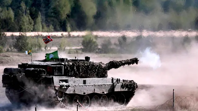 epa11316786 Norwegian servicemen their battle tank Leopard 2 participate in the Canadian Army Trophy (CAT) tank competition at Adazi Military Base, Latvia, 03 May 2024. The 'CAT 24' competition was held this year with crews from tank and combat vehicle units of Italy, Canada, Great Britain, Norway, Poland, Spain, and Germany. The exerciseÃŠaimed to work on unit tactics, techniques, and procedures, as well as sharing experiences to strengthen the integration and firepower of NATO allies. The competition was previously part of the 'Iron Spear' military exercise but has now regained its historical name. The winners of the competition will be awarded a special trophy. Canada leads NATO's extended presence battle group in Latvia, which currently consists of more than 1,900 soldiers from Albania, Canada, the Czech Republic, Iceland, Italy, Montenegro, North Macedonia, Poland, Slovakia, Slovenia, and Spain who serve alongside domestic armed forces on a rotating basis. EPA/VALDA KALNINA