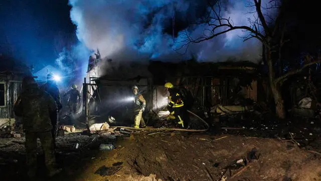 epa11258255 First responders work on the scene of an overnight drone attack in Kharkiv, northeastern Ukraine, 04 April 2024, amid the Russian invasion. At least four people were killed, including three rescuers, and 11 wounded, according to a report by the national police. In total, about 15 enemy drones were launched by Russia over the city of Kharkiv, with some of them being shot down by air defense forces, according to the head of the Kharkiv military administration Oleg Synegubov. Russian troops entered Ukrainian territory on 24 February 2022, starting a conflict that has provoked destruction and a humanitarian crisis. EPA/YAKIV LIASHENKO