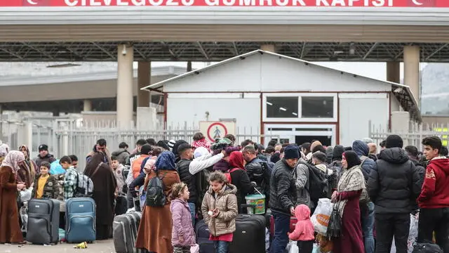 epa10481229 Syrian migrants wait to pass to Syria at the Cilvegozu border gate after a powerful earthquake in Reyhanli district of Hatay, Turkey, 21 February 2023. More than 46,000 people have died and thousands more are injured after two major earthquakes struck southern Turkey and northern Syria on 06 February. The Turkish government has reported that about 11,000 Syrian refugees, who fled to Turkey during the 12-year-long war, have returned to Syria following the after earthquake that effected Turkey and Syria. EPA/ERDEM SAHIN