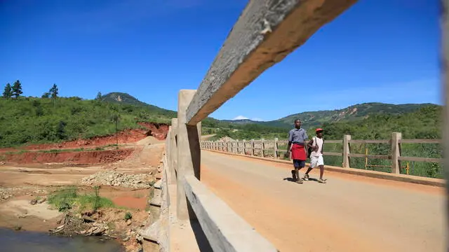 epa08293196 Youths walk along one rebuilt bridge one yaer after it was destroyed by Cyclone Idai in Chimanimani, Zimbabwe, 13 March 2020. Cylone Idai made landfall in Mozambique on 14 March and subsequently moved on to Malawi and Zimbabwe where it caimed at least 634 lives. Rebuilding of roads and bridges destroyed by cyclone Idai is still ongoing. Families whose homes were destroyed by the cyclone are still living in tents as the goverment is delaying in finding them alternative accomodation. EPA/AARON UFUMELI