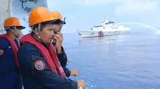 epa11314429 A handout photo made available by the Philippine Coast Guard (PCG) shows Filipino coastguard personnel on a patrol vessel viewing a Chinese Coast Guard (CCG) ship firing a water cannon at the vicinity of Scarborough Shoal in the disputed South China Sea, 30 April 2024 (issued 02 May 2024). The Philippine's foreign department on 02 May summoned the Chinese diplomatic mission's deputy chief Zhou Zhiyong following the latest confrontation and collision of vessels in the disputed South China. Manila claimed that two of its vessels were damaged 'due to water cannoning and ramming by Chinese ships' while conducting routine and regular humanitarian mission in the vicinity of Scarborough Shoal. EPA/PHILIPPINE COAST GUARD HANDOUT HANDOUT EDITORIAL USE ONLY/NO SALES HANDOUT EDITORIAL USE ONLY/NO SALES