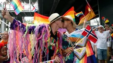 epa11383445 A foreign gay couple kiss during the LGBTQ+ parade to mark the Pride Month celebrations in Bangkok, Thailand, 01 June 2024. Thousands of Thai and international LGBTQIA+ participants take part in the annual Bangkok Pride parade to mark Pride Month under the 'Celebration of Love' concept to promote diversity and equal rights for all members of society as well as to celebrate the legalization of the Marriage Equality Act after Thai lawmakers passed the bill to legalize same-sex marriage, which makes Thailand to be the first Southeast Asia country to legalize same-sex marriage. The pride month is celebrated across the world annually in June to commemorate the 1969 Stonewall uprising to raise awareness and promote sexual diversity and equal rights for the Lesbian, Gay, Bisexual, Transgender, and Queer (LGBTQ) community. EPA/RUNGROJ YONGRIT