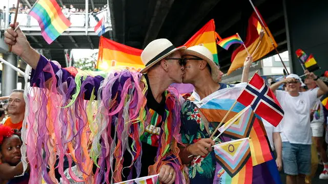 epa11383445 A foreign gay couple kiss during the LGBTQ+ parade to mark the Pride Month celebrations in Bangkok, Thailand, 01 June 2024. Thousands of Thai and international LGBTQIA+ participants take part in the annual Bangkok Pride parade to mark Pride Month under the 'Celebration of Love' concept to promote diversity and equal rights for all members of society as well as to celebrate the legalization of the Marriage Equality Act after Thai lawmakers passed the bill to legalize same-sex marriage, which makes Thailand to be the first Southeast Asia country to legalize same-sex marriage. The pride month is celebrated across the world annually in June to commemorate the 1969 Stonewall uprising to raise awareness and promote sexual diversity and equal rights for the Lesbian, Gay, Bisexual, Transgender, and Queer (LGBTQ) community. EPA/RUNGROJ YONGRIT