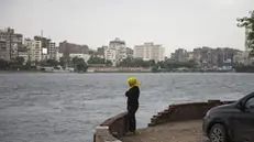 epa07942538 A girl stands on the bank of River Nile during a cloudy morning in Cairo, Egypt, 23 October 2019. According to reports, Egyptian meteorologists are forecasting unstable weather to prevail until 25 October, a day after heavy rain paralyzed traffic in the capital, forced the national carries EgyptAir to delay flights as passengers cannot reach the airport, and prompted prime minister to give day off for schools and universities. EPA/MOHAMED HOSSAM