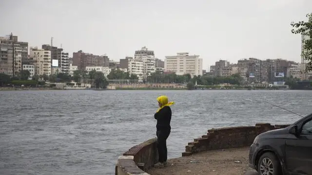 epa07942538 A girl stands on the bank of River Nile during a cloudy morning in Cairo, Egypt, 23 October 2019. According to reports, Egyptian meteorologists are forecasting unstable weather to prevail until 25 October, a day after heavy rain paralyzed traffic in the capital, forced the national carries EgyptAir to delay flights as passengers cannot reach the airport, and prompted prime minister to give day off for schools and universities. EPA/MOHAMED HOSSAM