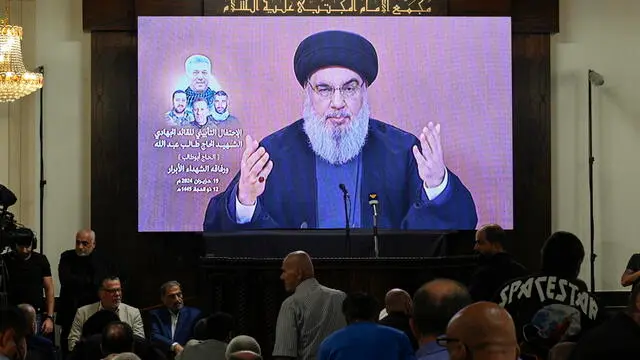 epa11423049 Hezbollah leader Hassan Nasrallah delivers a speech via a screen at a memorial ceremony for senior Field Commander, Taleb Sami Abdallah, known within Hezbollah as Hajj Abu Taleb who was killed on 11 June, in a suburb outside Beirut, in Beirut, Lebanon, 19 June 2024. Four Hezbollah fighters, including the senior field commander Taleb Sami Abdallah, were killed after the Israeli attack on a residential building in Jwaya town in the Tyre district, southern Lebanon on 11 June. EPA/WAEL HAMZEH