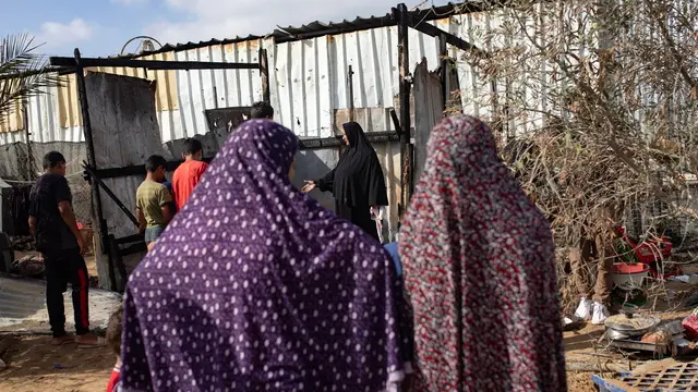 epa11421988 Palestinians inspect their tents after an Israeli military strike at an area designated as a 'safe zone' for displaced people, between Khan Yunis and Rafah, southern Gaza Strip, 19 June 2024. At least 24 people were killed and over 70 others injured in the past 24 hours, the Palestinian Ministry of Health said on 19 June. More than 37,000 Palestinians and over 1,400 Israelis have been killed, according to the Palestinian Health Ministry and the Israel Defense Forces (IDF), since Hamas militants launched an attack against Israel from the Gaza Strip on 07 October 2023, and the Israeli operations in Gaza and the West Bank which followed it. EPA/HAITHAM IMAD