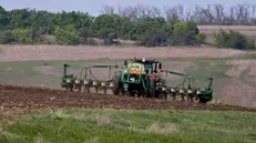 epa11290628 A tractor works in a field near Vysokopolie village, Kharkiv region, northeastern Ukraine, 20 April 2024, amid the ongoing Russian invasion. Ukrainian farmers , with the help of workers trained to use metal detectors, have their fields checked before agricultural machinery can do any work. If ammunition remnants are found, they ask sappers to assess whether they pose a threat. Once the danger is over, farmers are able to plant crops in the fields. Russian troops entered Ukraine in February 2022 starting a conflict that has provoked destruction and a humanitarian crisis. EPA/SERGEY KOZLOV