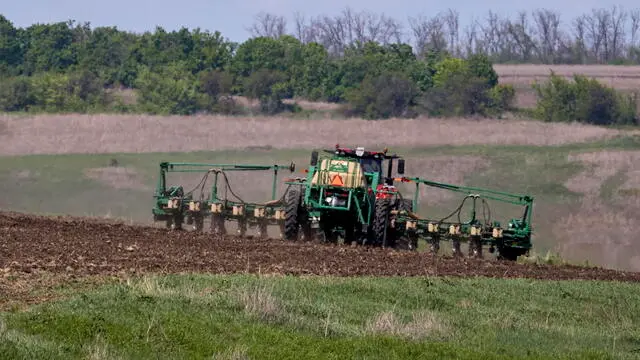 epa11290628 A tractor works in a field near Vysokopolie village, Kharkiv region, northeastern Ukraine, 20 April 2024, amid the ongoing Russian invasion. Ukrainian farmers , with the help of workers trained to use metal detectors, have their fields checked before agricultural machinery can do any work. If ammunition remnants are found, they ask sappers to assess whether they pose a threat. Once the danger is over, farmers are able to plant crops in the fields. Russian troops entered Ukraine in February 2022 starting a conflict that has provoked destruction and a humanitarian crisis. EPA/SERGEY KOZLOV