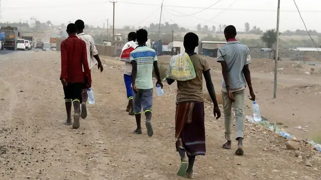 epa06945220 African migrants travel on foot from the coast of Shabwa province (500km), beside a road in the eastern province of Marib, Yemen, 05 August 2018 (issued 12 August 2018). For many of the migrants, who have traveled from their home countries in the Horn of Africa region, notably Somalia and Ethiopia, the long journey involves a risky voyage across the Gulf of Aden aboard a smugglerâs boat, before arriving on the shores of Yemen. After arriving on a beach in Yemen, migrants can walk hundreds of kilometers on foot through the desert landscape in order to reach towns or cities. EPA/YAHYA ARHAB