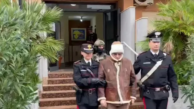 A handout photo made available by Italy's Carabinieri shows a video frame of the Mafia boss Matteo Messina Denaro (C), Italy's most wanted man, being arrested in Palermo, Sicily, by the Carabinieri police's ROS unit after 30 years on the run in Palermo, Sicily island, Italy, 16 January 2023. ANSA/US CARABINIERI +++ NO SALES, EDITORIAL USE ONLY +++ NPK +++