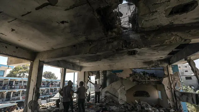 epa11392750 Palestinians inspect a destroyed UNRWA school following an Israeli air strike in Al Nusairat refugee camp in the central Gaza Strip, 06 June 2024. According to the Palestinian News Agency Wafa, at least 32 people were killed and dozens others were injured on early 06 June following an Israeli strike on a UNRWA school sheltering displaced Palestinians, located in the Nuseirat refugee camp in the central Gaza strip. The Israeli army said that it had "conducted a precise strike on a Hamas compound", whose members were " embedded in the UNRWA school". More than 36,000 Palestinians and over 1,400 Israelis have been killed, according to the Palestinian Health Ministry and the Israel Defense Forces (IDF), since Hamas militants launched an attack against Israel from the Gaza Strip on 07 October 2023, and the Israeli operations in Gaza and the West Bank which followed it. EPA/MOHAMMED SABER