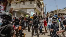 epa11406859 Hundred of demonstrators, including citizens and police members of the Solino district, march in the streets demanding justice for the three killed police officers on 09 June, by gangs lead led by Jimmy Cherizier, a.k.a Barbecue, in Port-Au-Prince, Haiti, 12 June 2024. Haiti's new prime minister Conille on 10 June condemned the gang killings of three police officers on patrol in a part of the capital controlled by gang leader Jimmy 'Barbecue' Cherizier. EPA/Mentor David Lorens