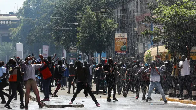 epa11436165 Demonstrators react as police use a water cannon and fire teargas during a protest against proposed tax hikes, in Nairobi, Kenya, 25 June 2024. Kenya's police on 25 June have sealed off the parliament and State House, and fired tear gas to disperse protesters demonstrating against planned tax hikes that many fear will worsen the cost-of-living crisis. EPA/DANIEL IRUNGU