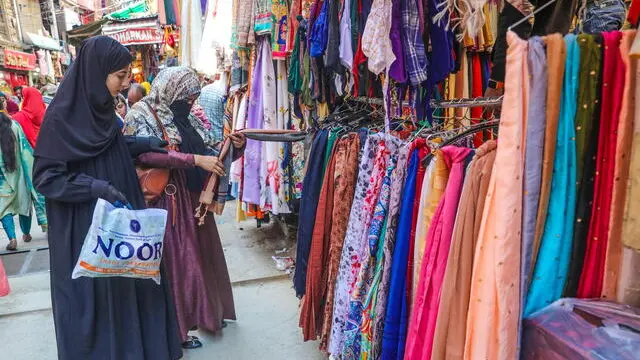 epa11265396 Kashmiri Muslim women check a dress as they shop ahead of the Eid al-Fitr holiday in Srinagar, the summer capital of Indian Kashmir, 08 April 2024. Eid al-Fitr is an Islamic holiday that marks the end of Ramadan, and is celebrated during the first three days of Shawwal, the 10th month of the Islamic calendar. It is expected to begin on 10 or 11 April 2024, depending on the lunar calendar. EPA/FAROOQ KHAN 49010