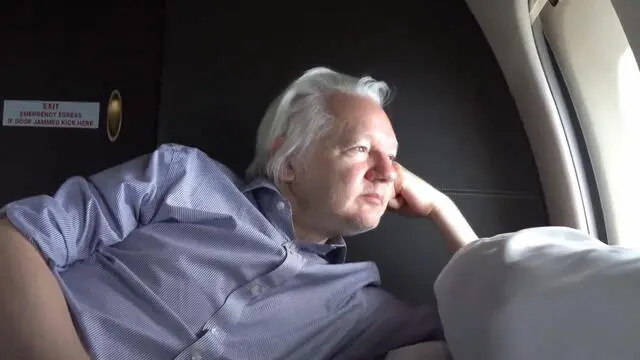 epa11437634 A still image taken from a handout video made available by WikiLeaks shows WikiLeaks founder Julian Assange looking out of the window of a plane at an undisclosed location, 25 June 2024. Julian Assange's flight VJT199 took off from Bangkok on 25 June, heading towards US airspace and Saipan Island, following a layover in the Thai capital. According to court filings in the US district court for the Northern Mariana Islands, US prosecutors said they anticipate Assange will plead guilty to the criminal count of conspiring to obtain and disclose classified documents relating to the national defense of the United States. WikiLeaks posted a statement on social media saying that Assange was freed from Britain's Belmarsh maximum security prison on 24 June morning, after having spent 1,901 days there. He was granted bail by the High Court in London and was released at Stansted Airport during the afternoon. Following his release on bail, he departed the UK for Australia. His wife Stella confirmed on X that 'Julian is free' and thanked supporters. EPA/WIKILEAKS HANDOUT -- MANDATORY CREDIT -- BEST QUALITY AVAILABLE -- HANDOUT EDITORIAL USE ONLY/NO SALES HANDOUT EDITORIAL USE ONLY/NO SALES