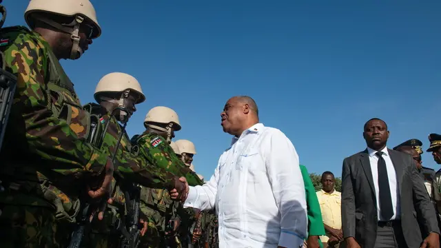 epa11439678 Haiti's Prime Minister Garry Conille (C) greets Kenyan police officers during a visit to the Multinational Mission base in Port-au-Prince, Haiti, 26 June 2024. The first Kenyan police deployed in Haiti, in response to an international request for assistance, begin to engage with a country they will help in addressing violence and restoring normalcy after years of crisis. EPA/Johnson Sabin