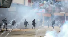 epaselect epa11441108 Demonstrators react as police fire teargas to disperse them during a renewed protest two days after deadly protests against tax hikes in Nairobi, Kenya, 27 June 2024. Kenyan President William Ruto said on 26 June that he wouldn't sign into law a finance bill proposing new tax hikes, a day after protesters stormed the parliament. At least 22 people have lost their lives in protests against tax hikes since 25 June 2024, according to Kenya National Human Rights Commission. EPA/DANIEL IRUNGU