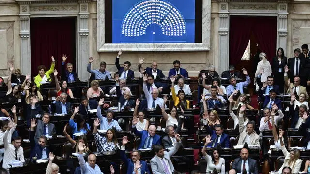 epa11122002 Argentine deputies participate in a plenary session in which the debate on the 'omnibus law,' promoted by the government of President Javier Milei, was resumed in Buenos Aires, Argentina, 02 February 2024. The 'omnibus law,' the main project of Milei's administration, with which they seek to implement a series of wide-ranging economic reforms in the country, was approved on 02 February in the Chamber of Deputies of the Argentine Congress by 144 votes in favor and 109 against. EPA/Matias Martin Campaya