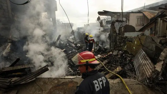 epaselect epa05582257 Filipino fire fighters extinguish remaining fire from fireworks stores in Bocaue, Bulacan, north of Manila, Philippines, 12 October 2016. According to reports at least one person was confirmed dead and twenty four were hurt after a fire hit a fireworks store in Bocaue, Bulacan, a place known for production of fireworks. EPA/KENJIE HASEGAWA