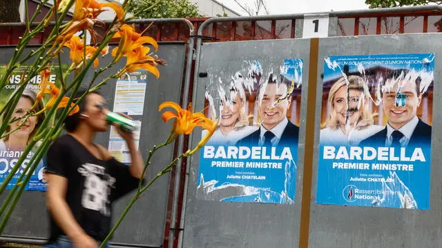 epa11444759 Legislative election posters on billboards, including French member of parliament and previous candidate for French presidential election Marine Le Pen (L) and Leader of the French extreme right party Rassemblement National (RN, National Front) Jordan Bardella (R), outside of polling station in Malakoff, near Paris, France, 29 June 2024. The upcoming snap legislative election in France takes place on 30 June and 07 July. EPA/Mohammed Badra