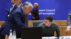 epa11441424 Hungarian Prime Minister Viktor Orban (L) and Ukraine's President Volodymyr Zelensky (R), take part at signature ceremony of security agreement with the EU, during European Council in Brussels, Belgium, 27 June 2024. EU leaders are gathering in Brussels for a two-day summit to discuss the Strategic Agenda 2024-2029, the next institutional cycle, Ukraine, the Middle East, competitiveness, security and defense, among other topics. EPA/OLIVIER HOSLET / POOL