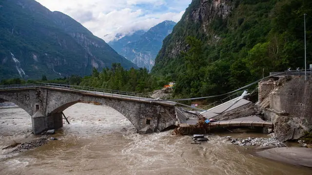 epa11448114 The collapsed Visletto bridge between Visletto and Cevio, in the Maggia Valley, southern Switzerland, 30 June 2024. The storm in the night from Saturday to Sunday destroyed various traffic routes. Following the landslide in the Maggia Valley, rescuers recovered two bodies on Sunday. A third body was later found in the same area. One person is still missing, according to the Ticino cantonal police in Valle Maggia. EPA/SAMUEL GOLAY