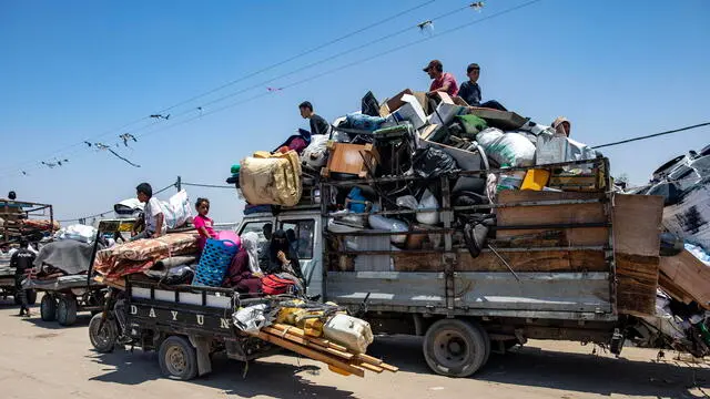 epa11443131 Palestinians flee displacement camps after the advance of Israeli army vehicles west of the city of Rafah in the southern Gaza Strip, 28 June 2024. Since 07 October 2023, up to 1.7 million people, or more than 75 percent of the population, have been displaced throughout the Gaza Strip, some more than once, in search of safety, according to the United Nations Relief and Works Agency for Palestine Refugees in the Near East (UNRWA), which added that the Palestinian enclave is 'on the brink of famine', with 1.1 million people (half of its population) 'experiencing catastrophic food insecurity' due to the conflict and restrictions on humanitarian access. EPA/HAITHAM IMAD