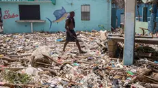 epaselect epa11455965 A man walks along the beach of Manresa, covered with garbage after the passage of Hurricane Beryl, in Santo Domingo, Dominican Republic, 3 July 2024. The Dominican Republic and Haiti emerged almost unscathed from the passage of Hurricane Beryl, whose main effect on the island of Hispaniola, shared by both countries, was the heavy swell that hit the Caribbean coast, and a few electricity and water supply issues. EPA/Orlando Barria