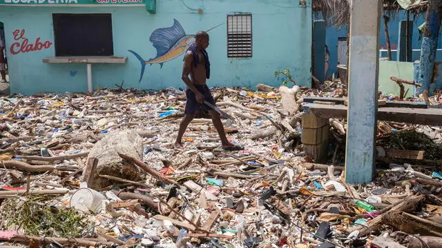 epaselect epa11455965 A man walks along the beach of Manresa, covered with garbage after the passage of Hurricane Beryl, in Santo Domingo, Dominican Republic, 3 July 2024. The Dominican Republic and Haiti emerged almost unscathed from the passage of Hurricane Beryl, whose main effect on the island of Hispaniola, shared by both countries, was the heavy swell that hit the Caribbean coast, and a few electricity and water supply issues. EPA/Orlando Barria