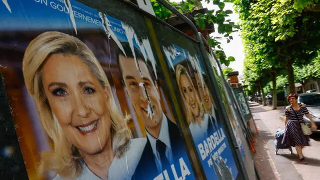 epa11444703 Legislative election posters on billboards, including French member of parliament and previous candidate for French presidential election Marine Le Pen (L) and Leader of the French extreme right party Rassemblement National (RN, National Front) Jordan Bardella (2-L), outside of polling station in Malakoff, near Paris, France, 29 June 2024. The upcoming snap legislative election in France takes place on 30 June and 07 July. EPA/Mohammed Badra