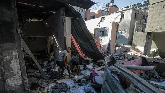 epa11435791 Palestinians inspect the destroyed home of Nasr family following an Israeli air strike in the Al-Maghazi refugee camp, southern Gaza Strip, 25 June 2024. According to a report from the Palestinian Ministry of Health, five Palestinians were killed and more than 12 injured overnight in an Israeli air strike on the Al-Maghazi refugee camp. More than 37,000 Palestinians and over 1,400 Israelis have been killed, according to the Palestinian Health Ministry and the Israel Defense Forces (IDF), since Hamas militants launched an attack against Israel from the Gaza Strip on 07 October 2023, and the Israeli operations in Gaza and the West Bank which followed it. EPA/MOHAMMED SABER