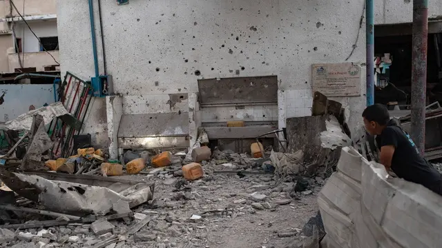 epa11464091 A Palestinian looks on damages after the Israeli air strike hit UNRWA's Al-Jaouni School housing displaced people in the Nuseirat refugee camp in the central Gaza Strip, 06 July 2024. At least 16 people have died and 50 are injured in an Israeli attack on a UN school in central Gaza Strip, according to the Palestinian health ministry . Israeli army (IDF) confirmed the strike following what it said was information about the location being used as 'a hideout' from where attacks against the IDF were 'directed and carried out'. EPA/HAITHAM IMAD