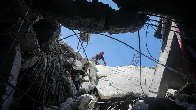 epaselect epa11467959 A Palestinian man inspects the rubble of a destroyed building following an Israeli air strike in Al Nuseirat refugee camp, central Gaza Strip, 09 July 2024. More than 16 Palestinians have been killed following Israeli air strikes in Al Nuseirat refugee camp on 09 July, according to the Palestinian Ministry of Health. The Israeli military stated that its troops are continuing 'operational activity' throughout the Gaza Strip. More than 38,000 Palestinians and over 1,455 Israelis have been killed, according to the Palestinian Health Ministry and the IDF, since Hamas militants launched an attack against Israel from the Gaza Strip on 07 October 2023, and the Israeli operations in Gaza and the West Bank which followed it. EPA/MOHAMMED SABER