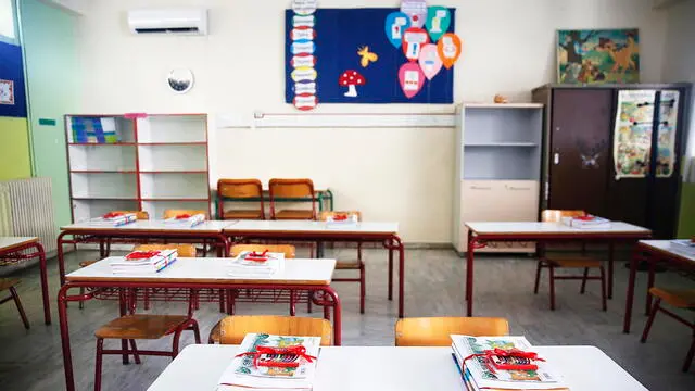 epa10854964 School books placed on desks at the 7th Primary School of Agioi Anargyri, Attiki, Greece, 11 September 2023. The new school year began with the customary consecration for the students of Kindergarten, Elementary, Middle Schools and High Schools. EPA/ALEXANDROS VLACHOS