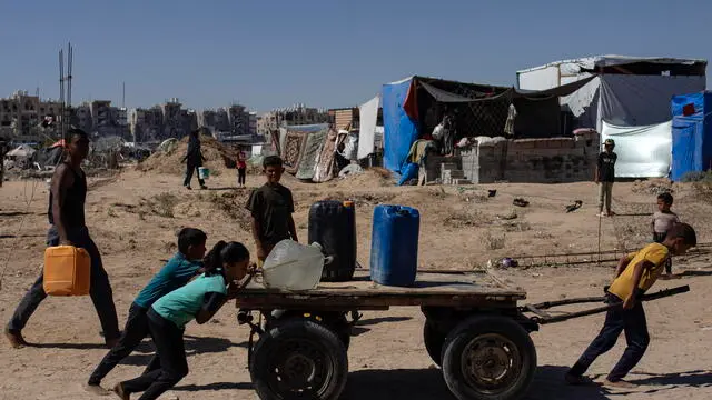 epa11455944 Children move a cart with containers as displaced Palestinians collect drinking water from a water tanker at a makeshift camp in the Khan Yunis refugee camp in the southern Gaza Strip, 03 July 2024. Since 07 October 2023, up to 1.7 million people, or more than 75 percent of the population, have been displaced throughout the Gaza Strip, some more than once, in search of safety, according to the United Nations Relief and Works Agency for Palestine Refugees in the Near East (UNRWA), which added that the Palestinian enclave is 'on the brink of famine', with 1.1 million people (half of its population) 'experiencing catastrophic food insecurity' due to the conflict and restrictions on humanitarian access. EPA/HAITHAM IMAD