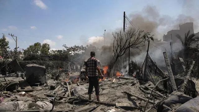 epa11475530 Palestinians inspect the scene after an Israeli raid on the tents of displaced people in the Al-Mawasi area of Khan Yunis in the southern Gaza Strip, 13 July 2024. Gazaâ€™s health ministry said at least 71 Palestinians were killed in the Israeli attack in Khan Younis, 289 others were injured. Israeli military confirmed it targeted Hamas military chief, Mohammed Deif, in Saturdayâ€™s attack in Gaza. EPA/HAITHAM IMAD