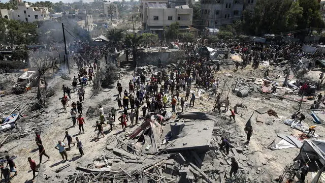 epaselect epa11475531 Palestinians inspect the scene after an Israeli raid on the tents of displaced people in the Al-Mawasi area of Khan Yunis in the southern Gaza Strip, 13 July 2024. Gazaâ€™s health ministry said at least 71 Palestinians were killed in the Israeli attack in Khan Younis, 289 others were injured. Israeli military confirmed it targeted Hamas military chief, Mohammed Deif, in Saturdayâ€™s attack in Gaza. EPA/HAITHAM IMAD