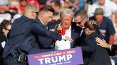 epa11476747 Former US President Donald Trump is rushed off stage by secret service after an incident during a campaign rally at the Butler Farm Show Inc. in Butler, Pennsylvania, USA, 13 July 2024. EPA/DAVID MAXWELL
